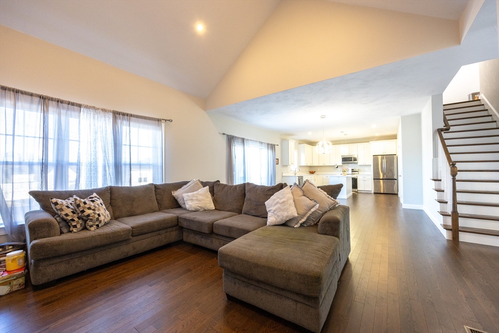 1 Clover Drive Bellingham, MA 02019 - Photo 11 of 34 a living room with furniture and a wooden floor