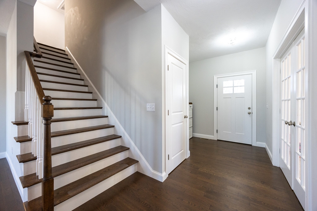 1 Clover Drive Bellingham, MA 02019 - Photo 16 of 34 a view of a hallway with wooden floor and entryway