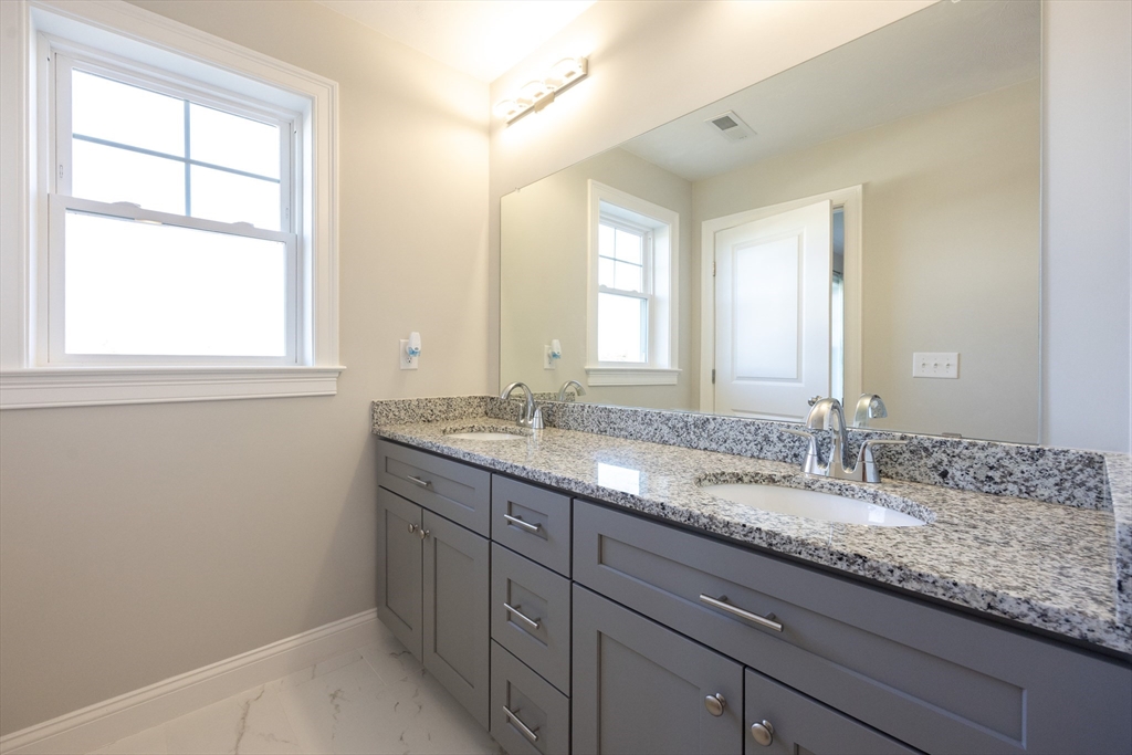1 Clover Drive Bellingham, MA 02019 - Photo 20 of 34 a bathroom with a granite countertop sink and a large mirror