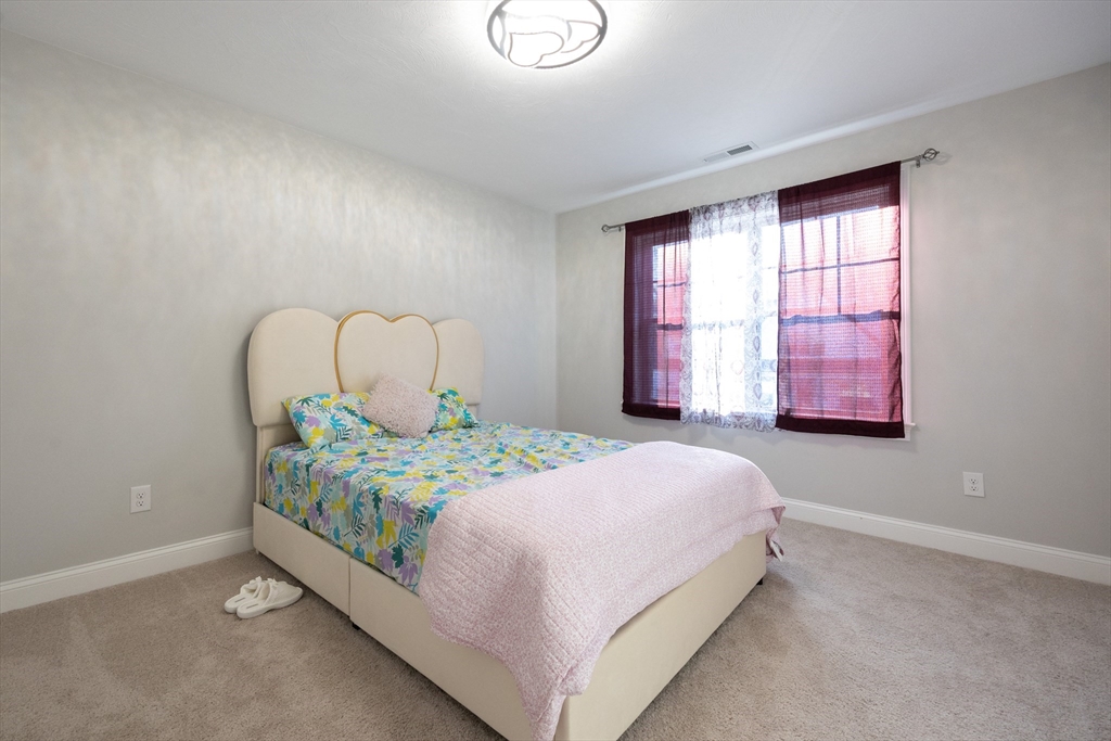 1 Clover Drive Bellingham, MA 02019 - Photo 23 of 34 a bedroom with a bed table and window