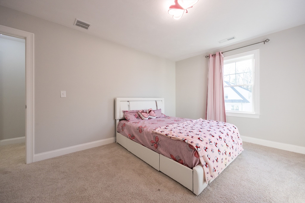 1 Clover Drive Bellingham, MA 02019 - Photo 25 of 34 a bedroom with a bed and a window