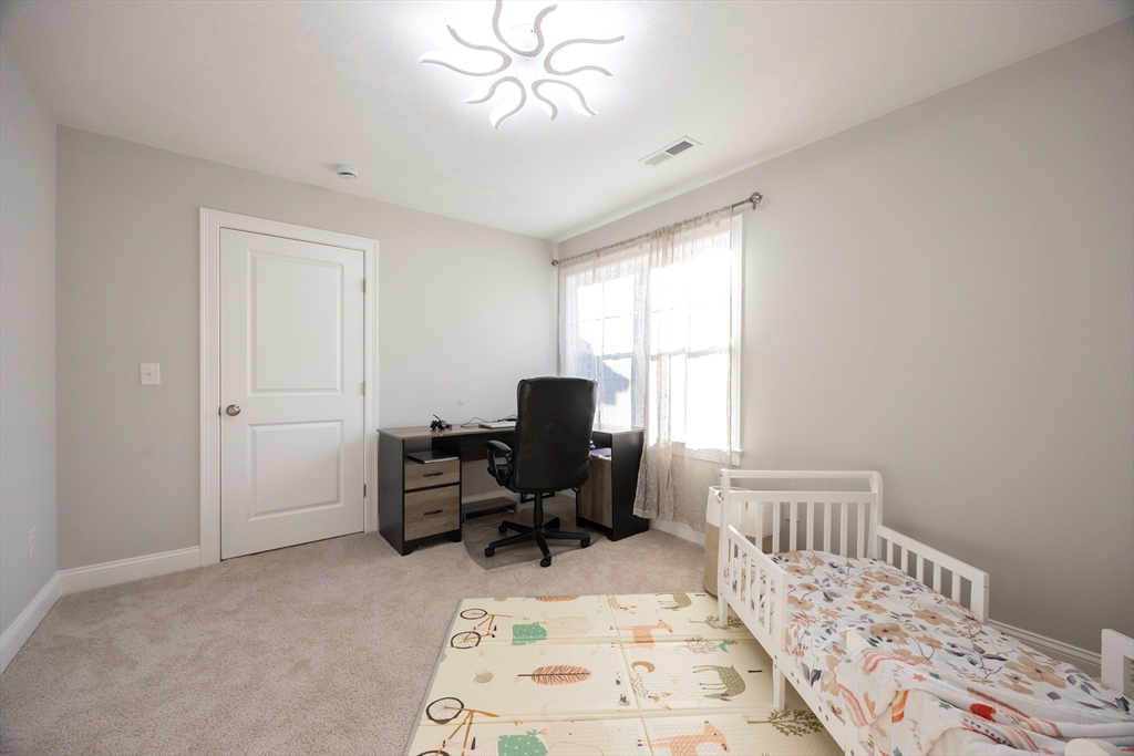 1 Clover Drive Bellingham, MA 02019 - Photo 27 of 34 a view of a bedroom with workspace and windows