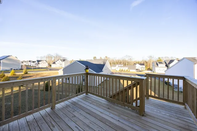 a view of roof deck with wooden floor and fence