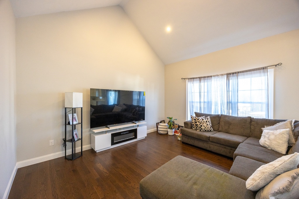 1 Clover Drive Bellingham, MA 02019 - Photo 10 of 34 a living room with furniture and a flat screen tv
