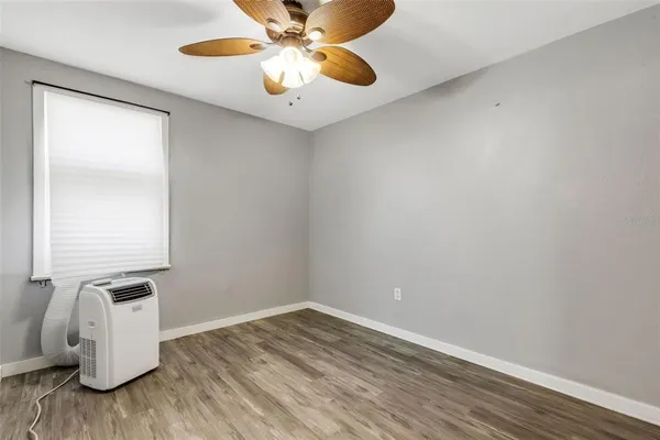 a view of an empty room and wooden floor