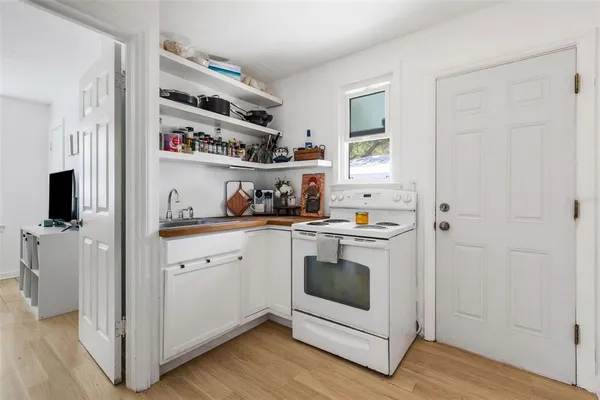 a kitchen with a stove and a white cabinets