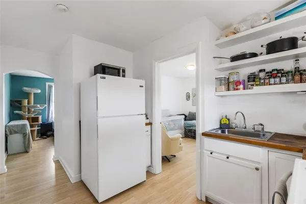 a white refrigerator freezer sitting in a kitchen