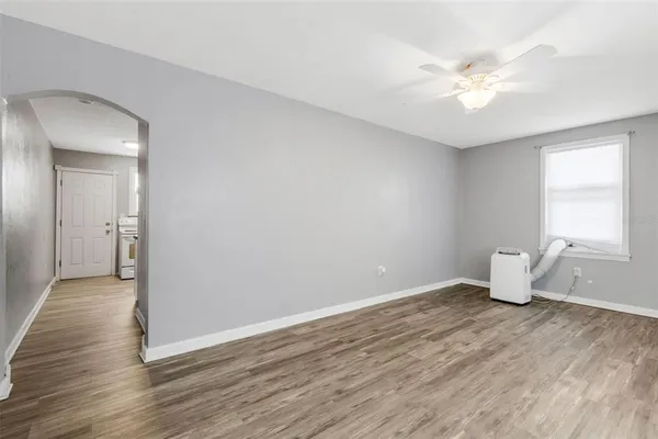 a room with wooden floor and white walls