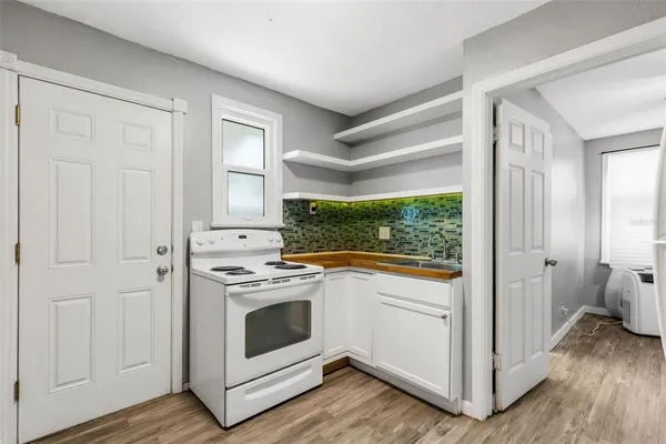a view of a kitchen with a stove top oven