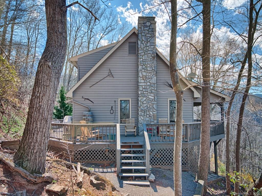 900 Mountain Cove Road Waynesville, NC 28786 - Photo 2 of 24 a front view of house with outdoor seating and trees