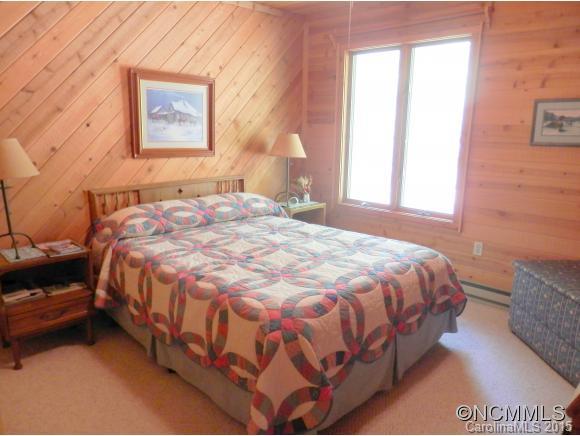 900 Mountain Cove Road Waynesville, NC 28786 - Photo 13 of 24 a bedroom with a bed and a couch