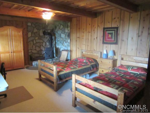 900 Mountain Cove Road Waynesville, NC 28786 - Photo 14 of 24 a bedroom with bed and a night stand