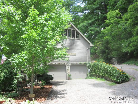 900 Mountain Cove Road Waynesville, NC 28786 - Photo 20 of 24 a front view of a house with a yard and garage
