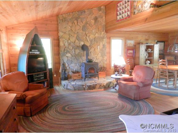 900 Mountain Cove Road Waynesville, NC 28786 - Photo 10 of 24 a living room with furniture and a fireplace