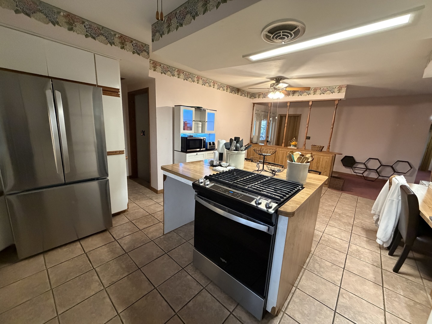 4019 5th Street East Moline, IL 61244 - Photo 8 of 37 a kitchen with a stove a refrigerator and a microwave