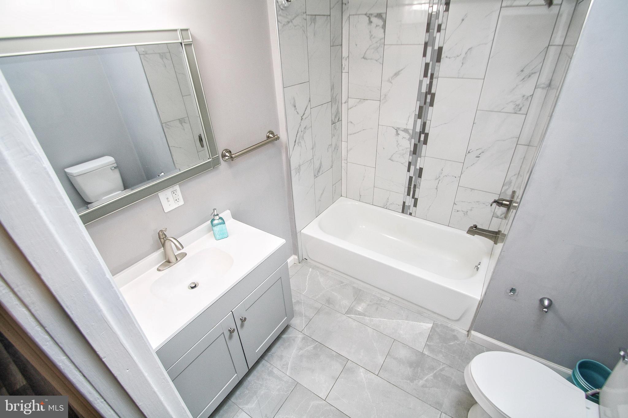 268 Sanford Road Upper Darby, PA 19082 - Photo 19 of 25 a bathroom with a sink a toilet and shower