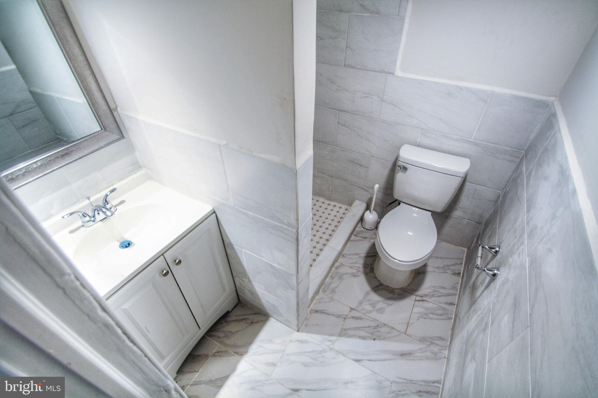 268 Sanford Road Upper Darby, PA 19082 - Photo 23 of 25 a bathroom with a sink toilet and mirror