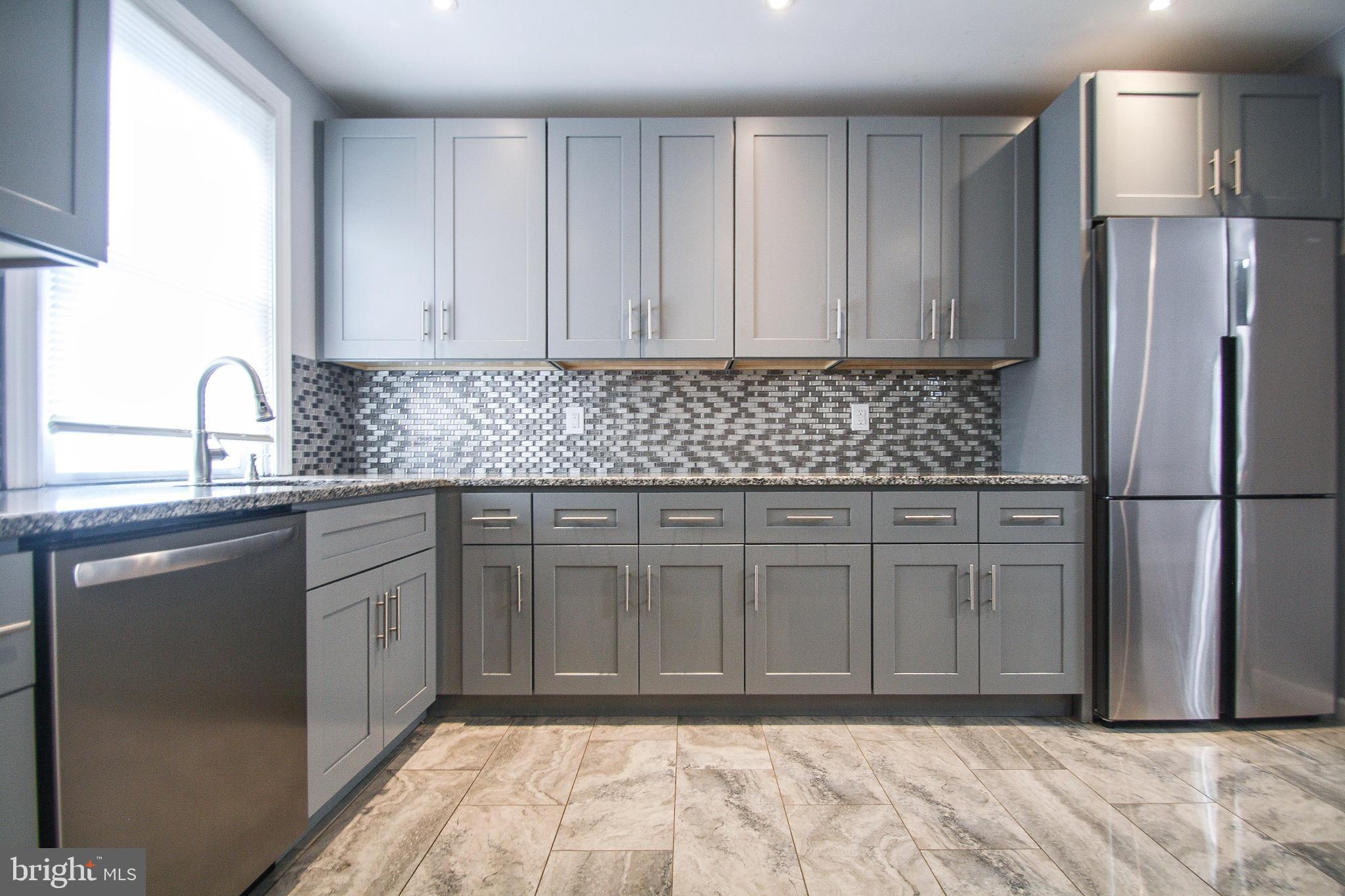 268 Sanford Road Upper Darby, PA 19082 - Photo 10 of 25 a kitchen with stainless steel appliances granite countertop a refrigerator sink and cabinets