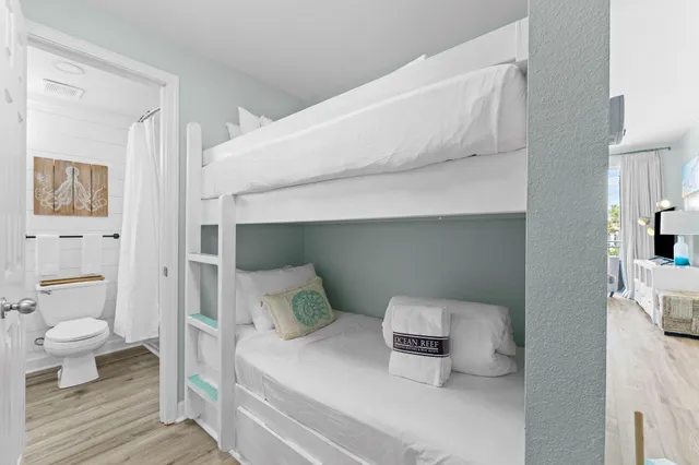 a bedroom with a bed and wooden floor