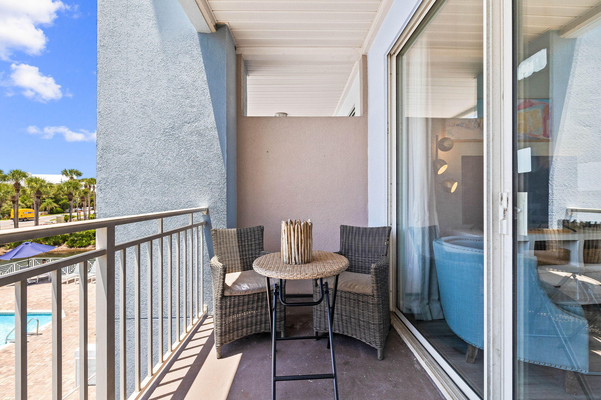 145 Spires Lane, Unit 205 Santa Rosa Beach, FL 32459 - Photo 19 of 40 a balcony with chairs and a potted plant on a table