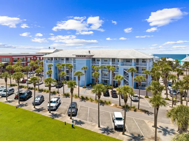 an aerial view of a swimming pool with outdoor seating