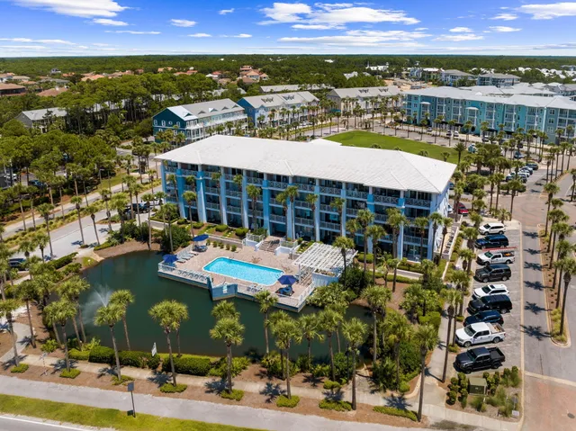 a view of a swimming pool with outdoor seating and plants