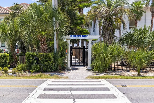 a view of a pathway with a wrought fence