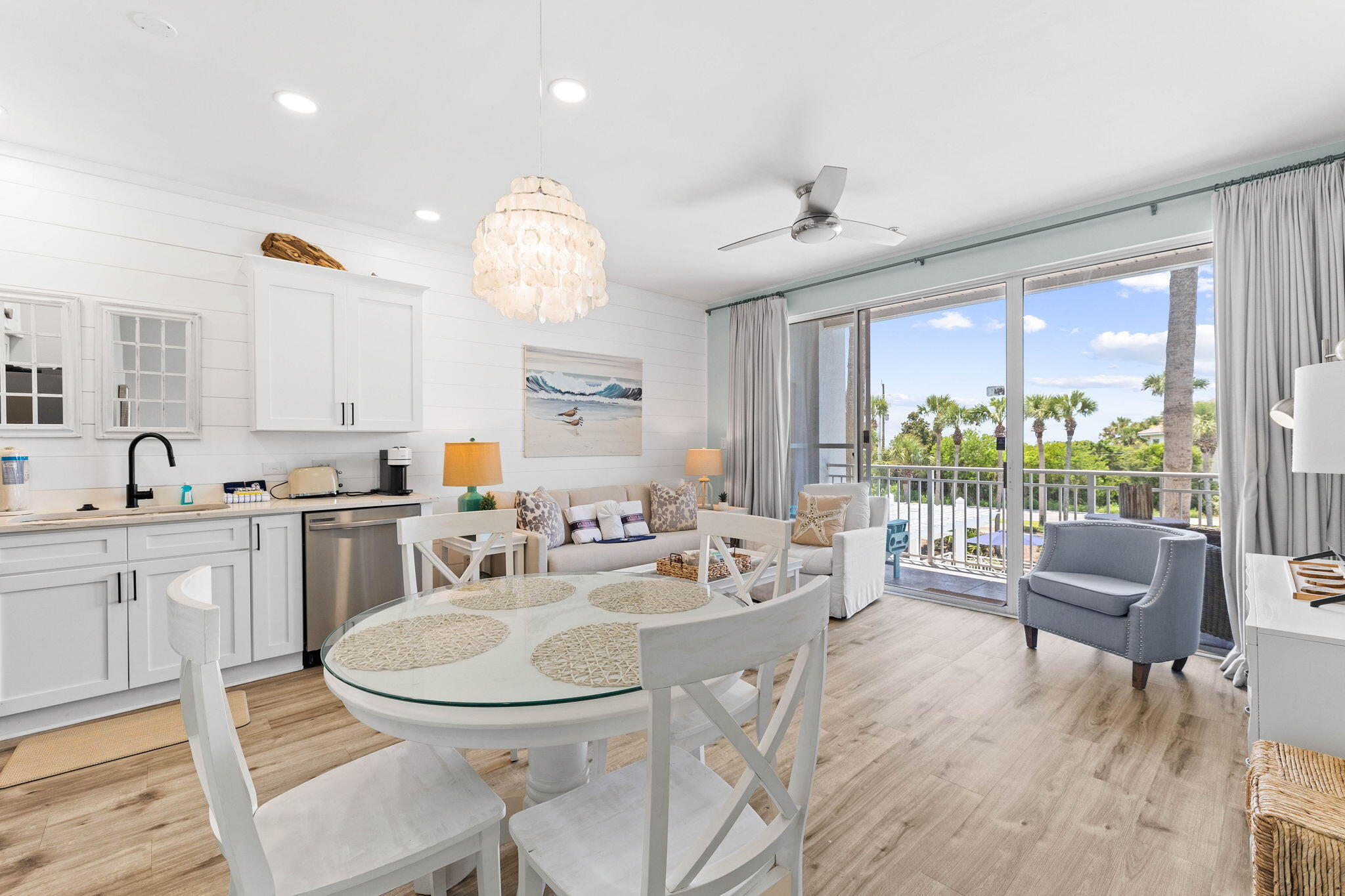 145 Spires Lane, Unit 205 Santa Rosa Beach, FL 32459 - Photo 10 of 40 a kitchen with granite countertop a stove a sink a dining table and chairs
