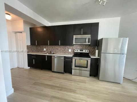 7135 Collins Avenue, Unit PH31 Miami Beach, FL 33141 - Photo 3 of 20 a kitchen with stainless steel appliances granite countertop a refrigerator stove a sink and dishwasher