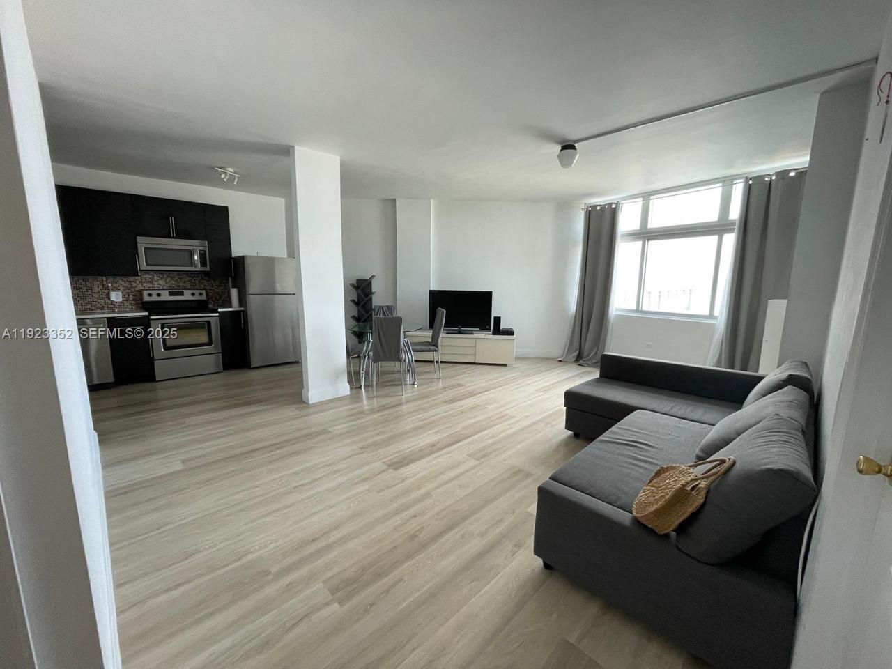 7135 Collins Avenue, Unit PH31 Miami Beach, FL 33141 - Photo 4 of 20 a living room with furniture and a flat screen tv