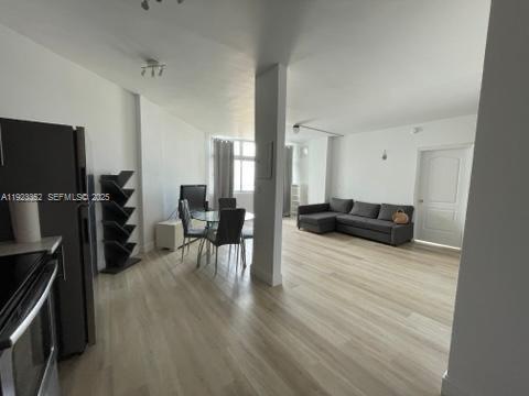7135 Collins Avenue, Unit PH31 Miami Beach, FL 33141 - Photo 5 of 20 a living room with furniture and a flat screen tv