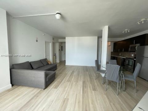 7135 Collins Avenue, Unit PH31 Miami Beach, FL 33141 - Photo 6 of 20 a living room with furniture and a wooden floor