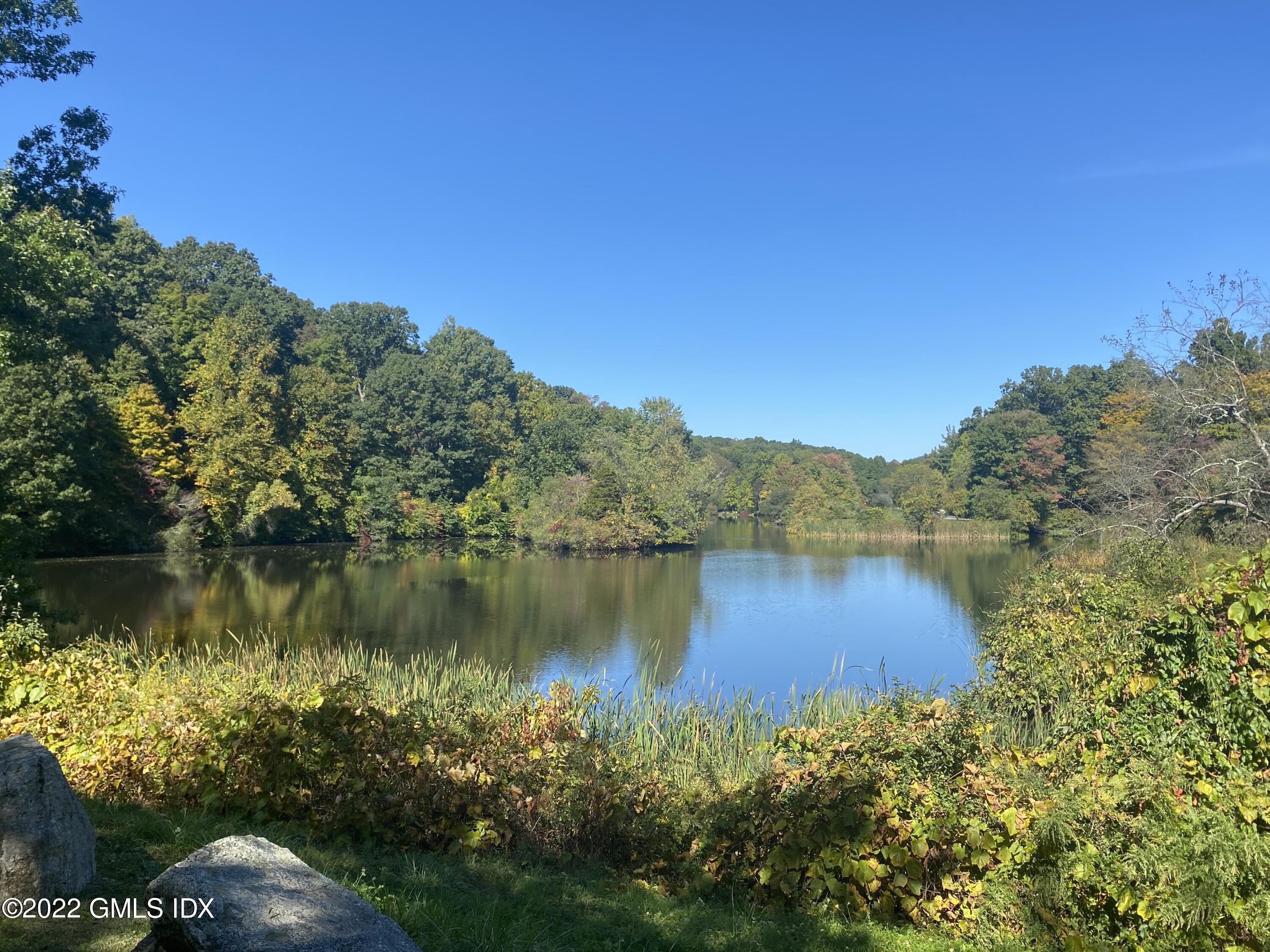 57 Partridge Hollow Road Greenwich, CT 06831 - Photo 102 of 102 a view of a lake with a mountain in the background