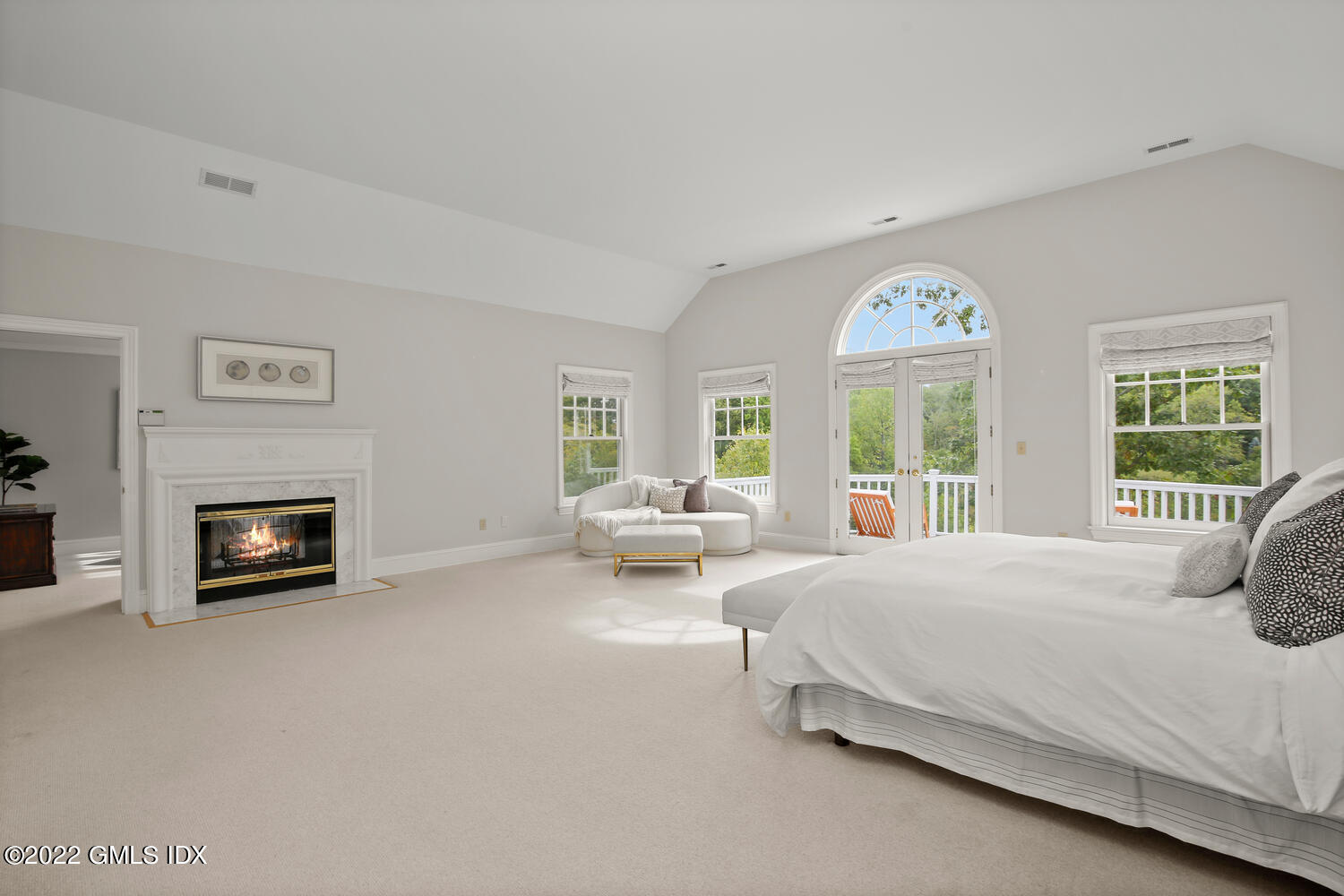 57 Partridge Hollow Road Greenwich, CT 06831 - Photo 39 of 102 a spacious bedroom with a bed and a fireplace