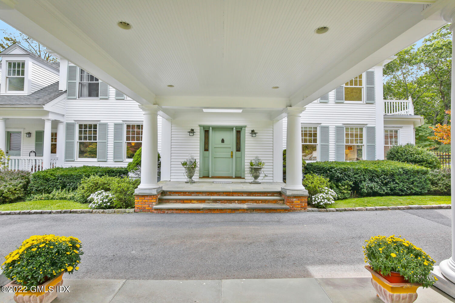 57 Partridge Hollow Road Greenwich, CT 06831 - Photo 4 of 102 a front view of a house with a yard and outdoor seating