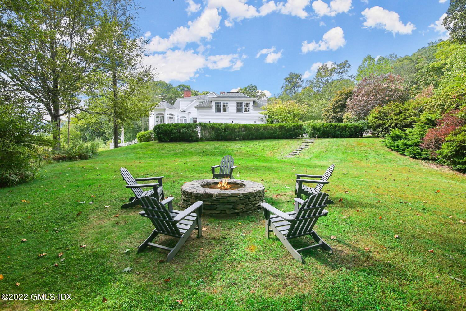 57 Partridge Hollow Road Greenwich, CT 06831 - Photo 70 of 102 a view of a table and chairs in the garden