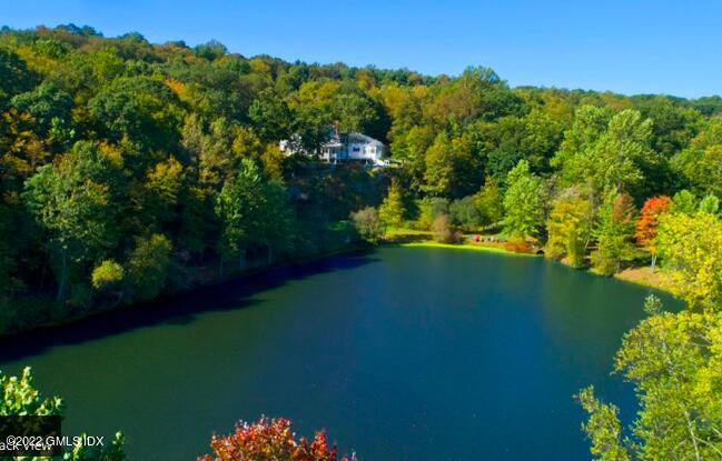 57 Partridge Hollow Road Greenwich, CT 06831 - Photo 78 of 102 a view of a lake with a yard