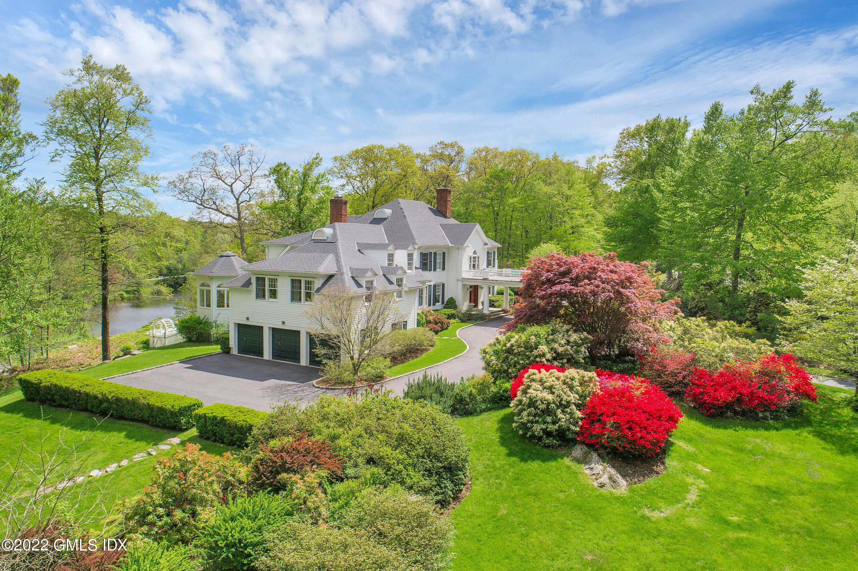 57 Partridge Hollow Road Greenwich, CT 06831 - Photo 82 of 102 a aerial view of a house with a big yard and large trees