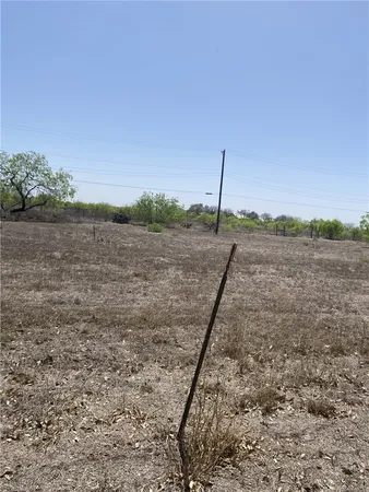 a view of a dry yard with a lake