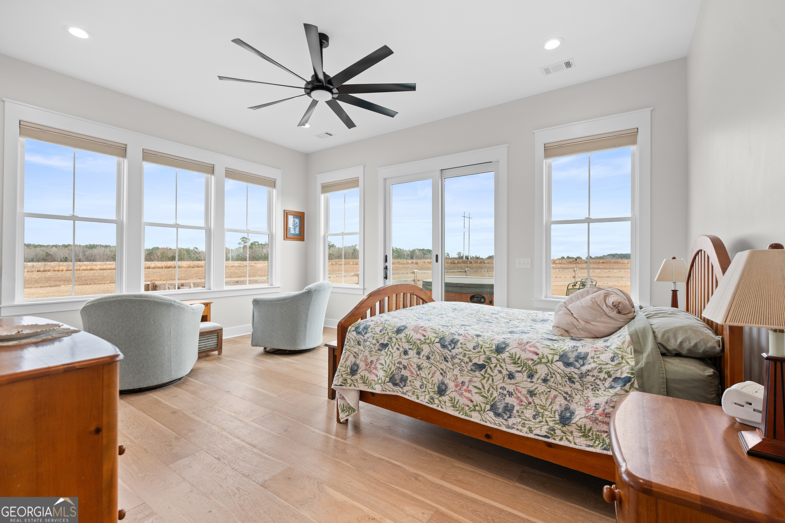 430 Jack Kennedy Road Statesboro, GA 30458 - Photo 14 of 44 a bedroom with a large bed and large windows