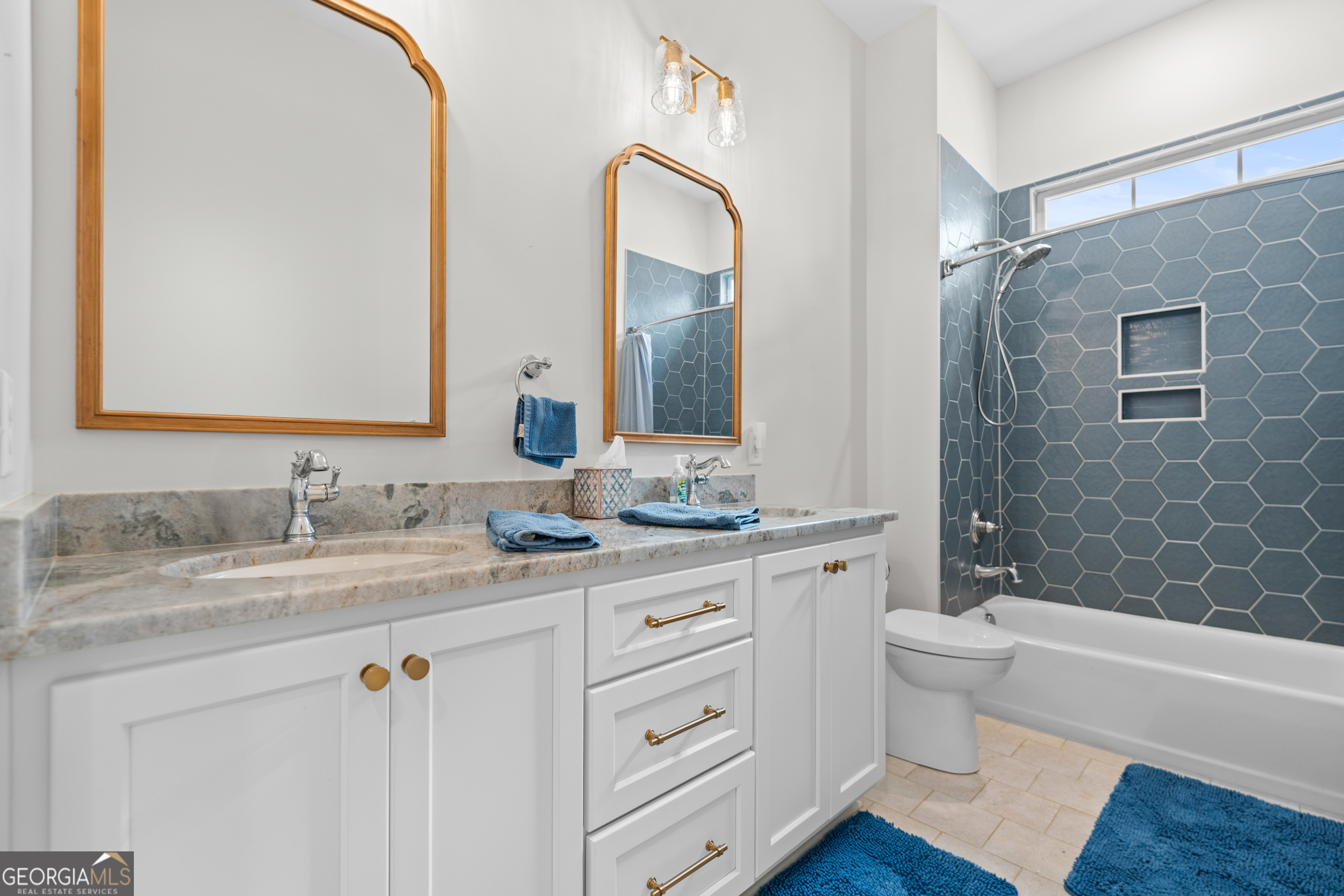 430 Jack Kennedy Road Statesboro, GA 30458 - Photo 21 of 44 a bathroom with a granite countertop sink a toilet and a bathtub