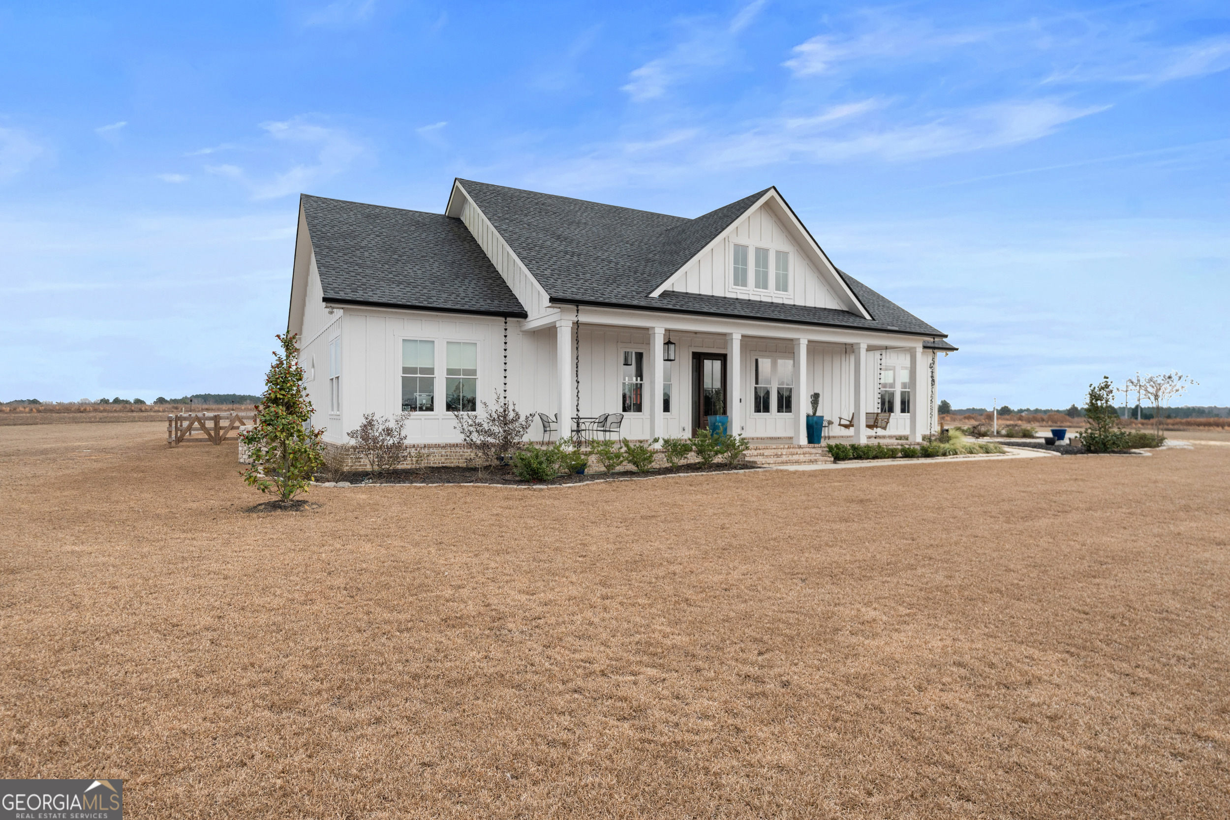430 Jack Kennedy Road Statesboro, GA 30458 - Photo 4 of 44 a front view of a house with a yard