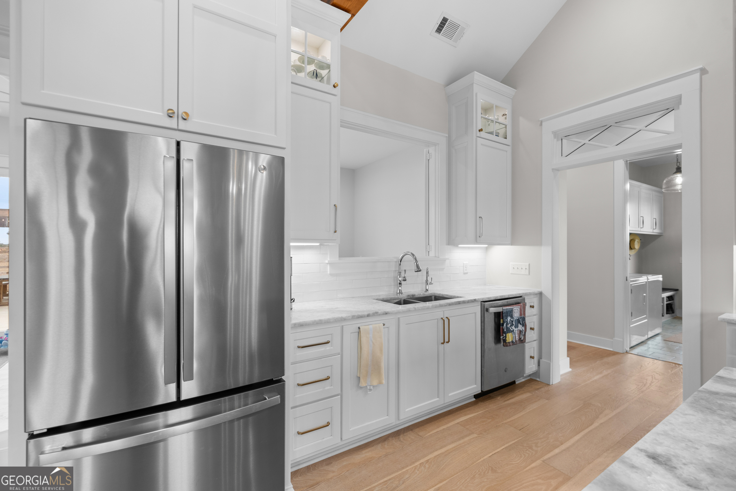 430 Jack Kennedy Road Statesboro, GA 30458 - Photo 10 of 44 a kitchen with stainless steel appliances a refrigerator sink and cabinets