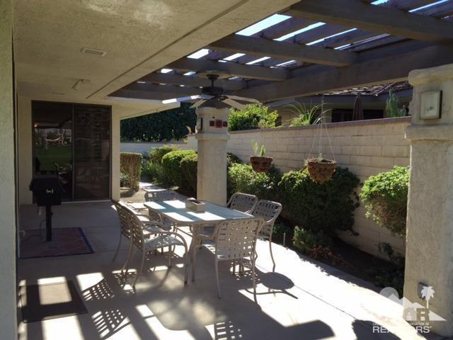 8 Duke Drive Rancho Mirage, CA 92270 - Photo 15 of 15 a patio with table and chairs and potted plants