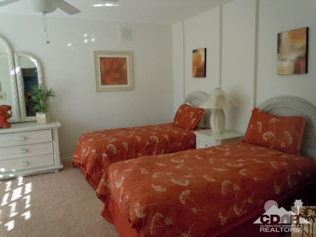 8 Duke Drive Rancho Mirage, CA 92270 - Photo 7 of 15 a bedroom with two beds and a painting on the wall