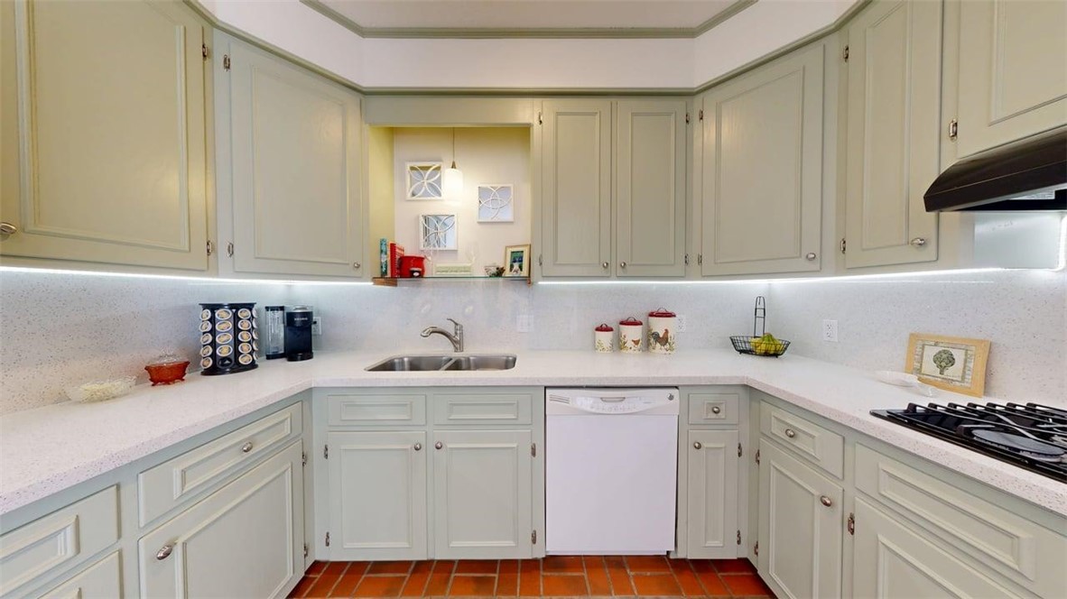705 Walker Street Bryan, TX 77802 - Photo 11 of 46 a kitchen with white cabinets and white appliances
