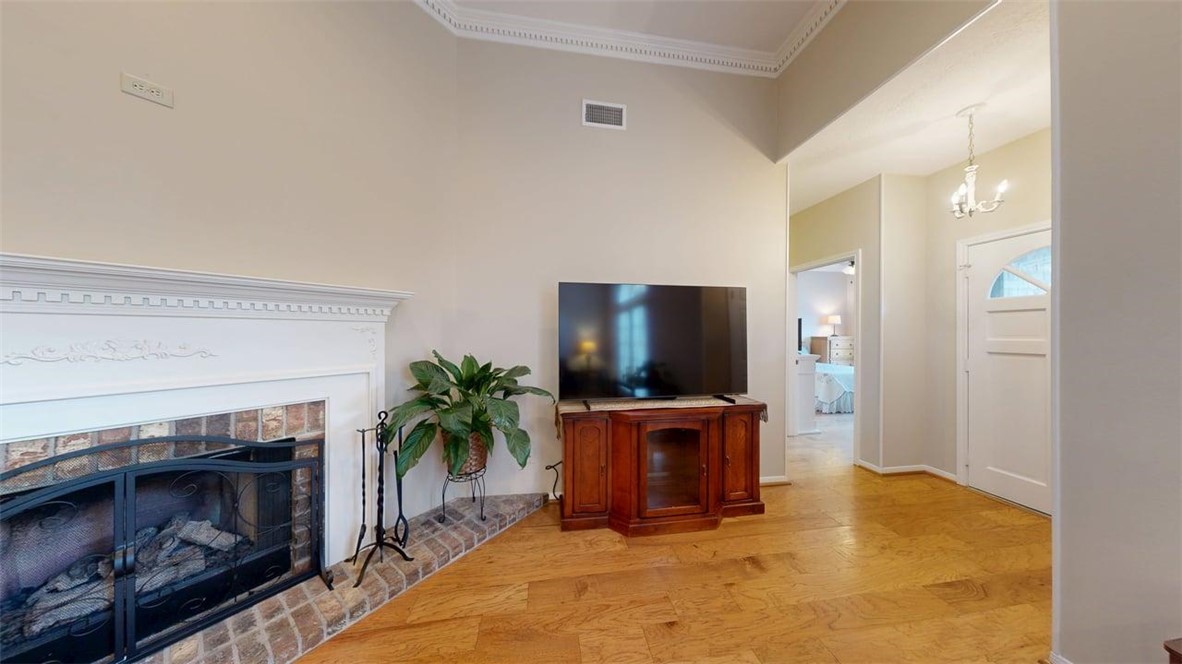 705 Walker Street Bryan, TX 77802 - Photo 14 of 46 a living room with furniture a flat screen tv and a fireplace