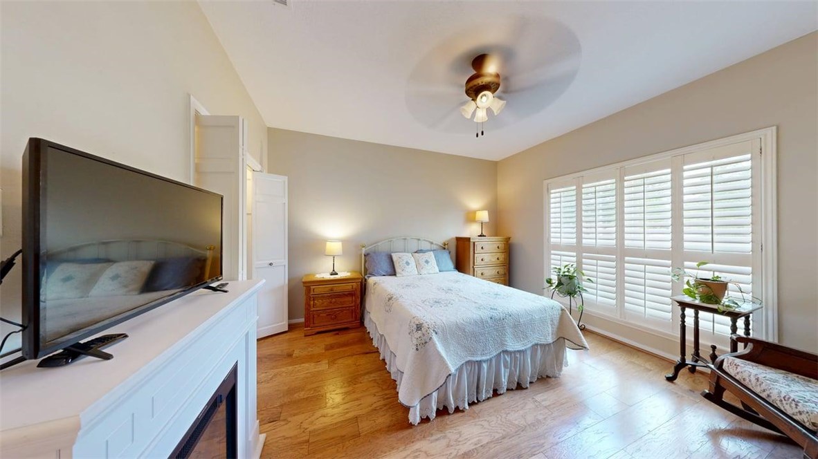 705 Walker Street Bryan, TX 77802 - Photo 16 of 46 a spacious bedroom with a bed and large windows
