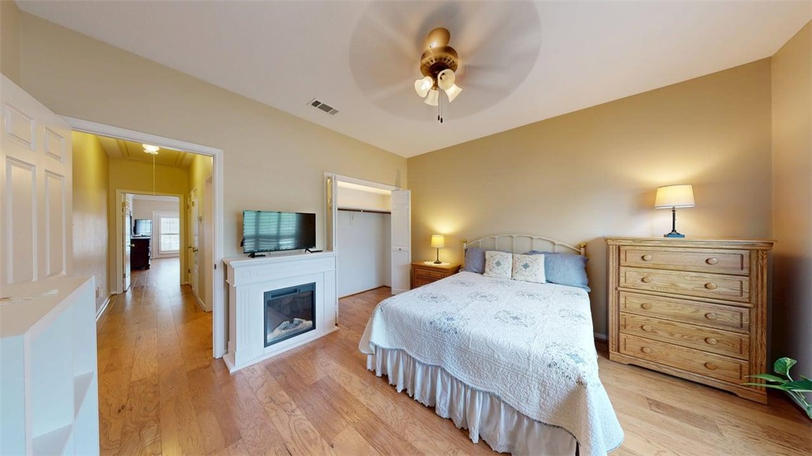 705 Walker Street Bryan, TX 77802 - Photo 18 of 46 a bedroom with a bed and a chandelier
