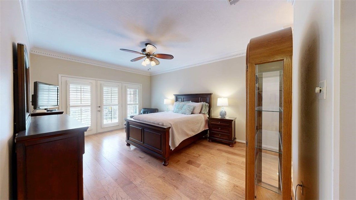 705 Walker Street Bryan, TX 77802 - Photo 21 of 46 a spacious bedroom with a large bed and a chandelier